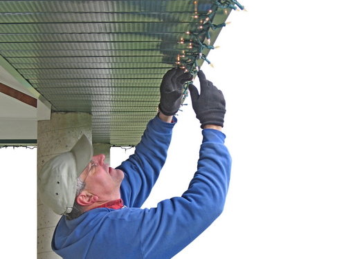 Man installing Christmas lights